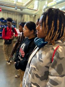 Students watching and listening during maker space tour